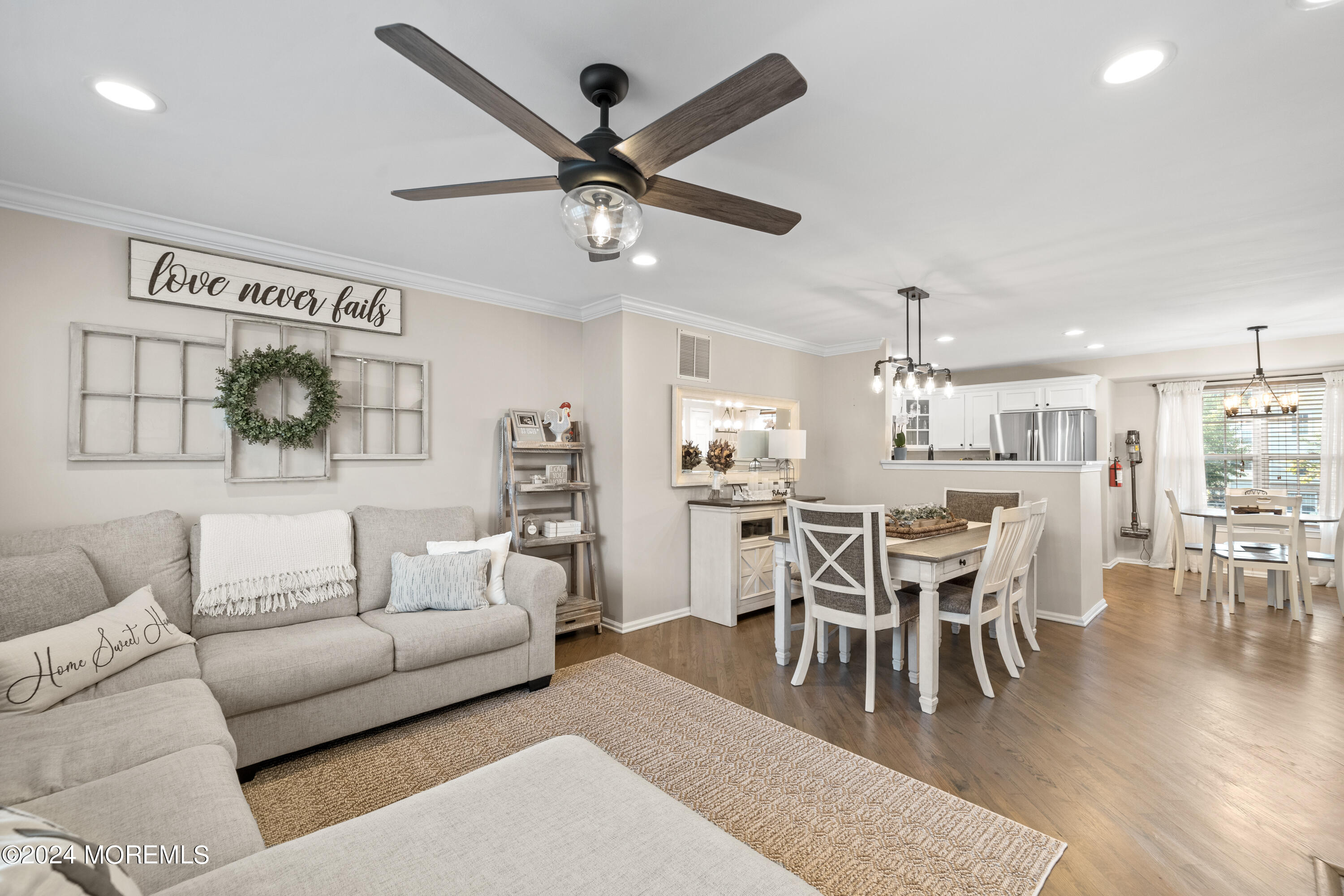 5 Kuczynski Drive, Unit 945 Parlin, NJ 08859 - Photo 20 of 62 a living room with furniture a view of dining room and a wooden floor