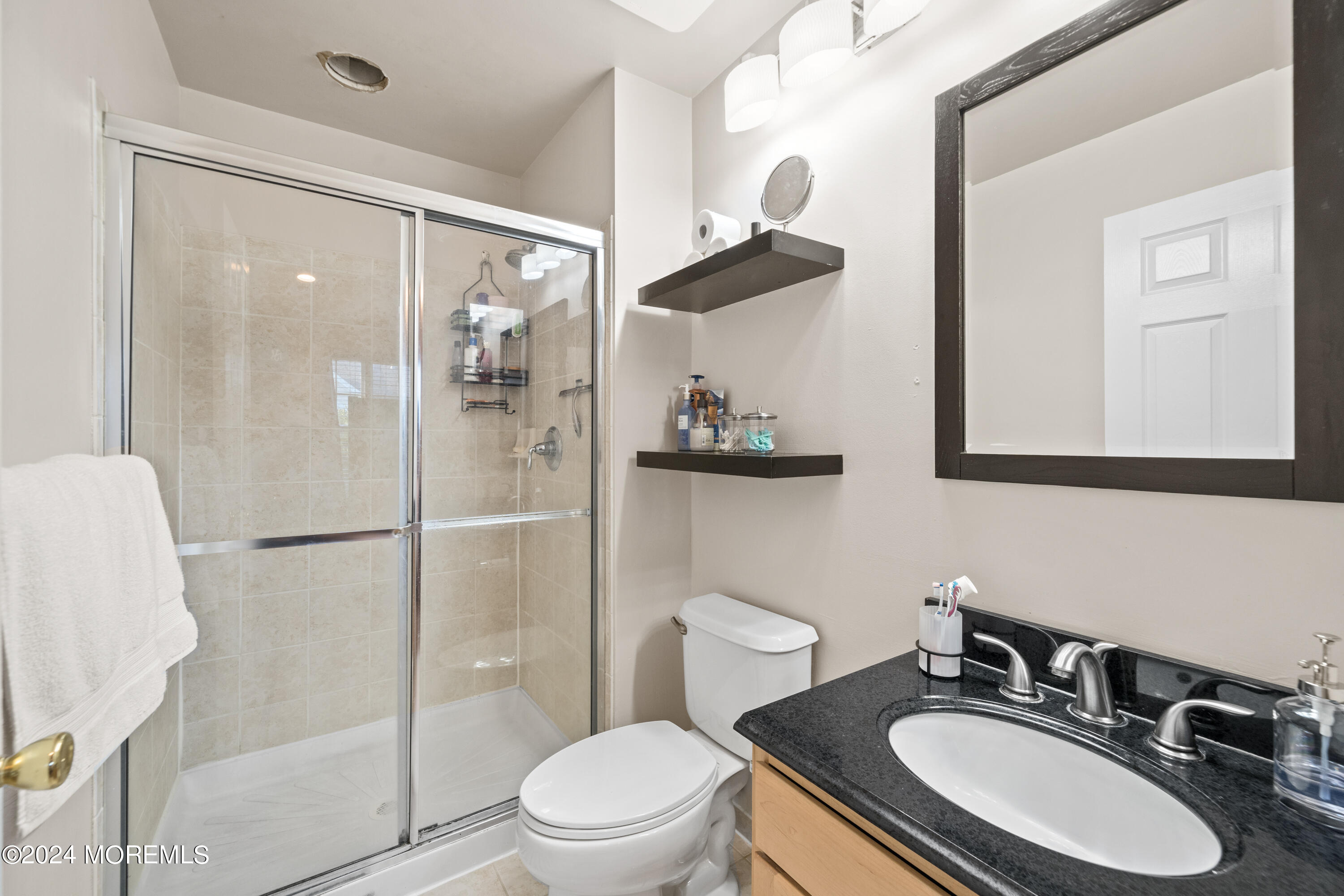 5 Kuczynski Drive, Unit 945 Parlin, NJ 08859 - Photo 35 of 62 a bathroom with a sink toilet a mirror and shower