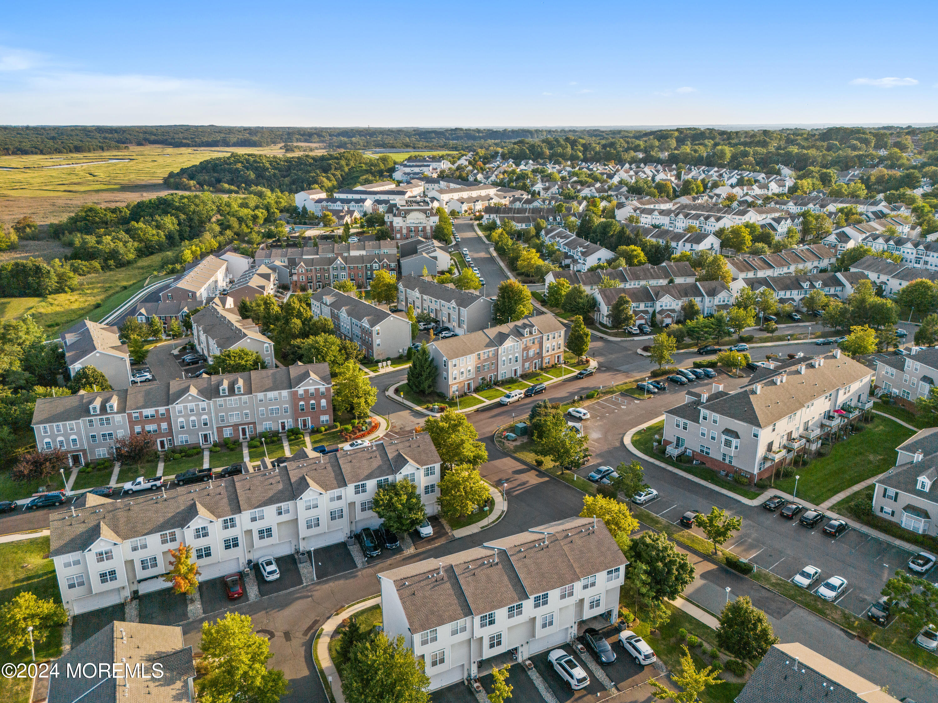 5 Kuczynski Drive, Unit 945 Parlin, NJ 08859 - Photo 53 of 62 an aerial view of a city with lots of residential buildings and ocean view in back