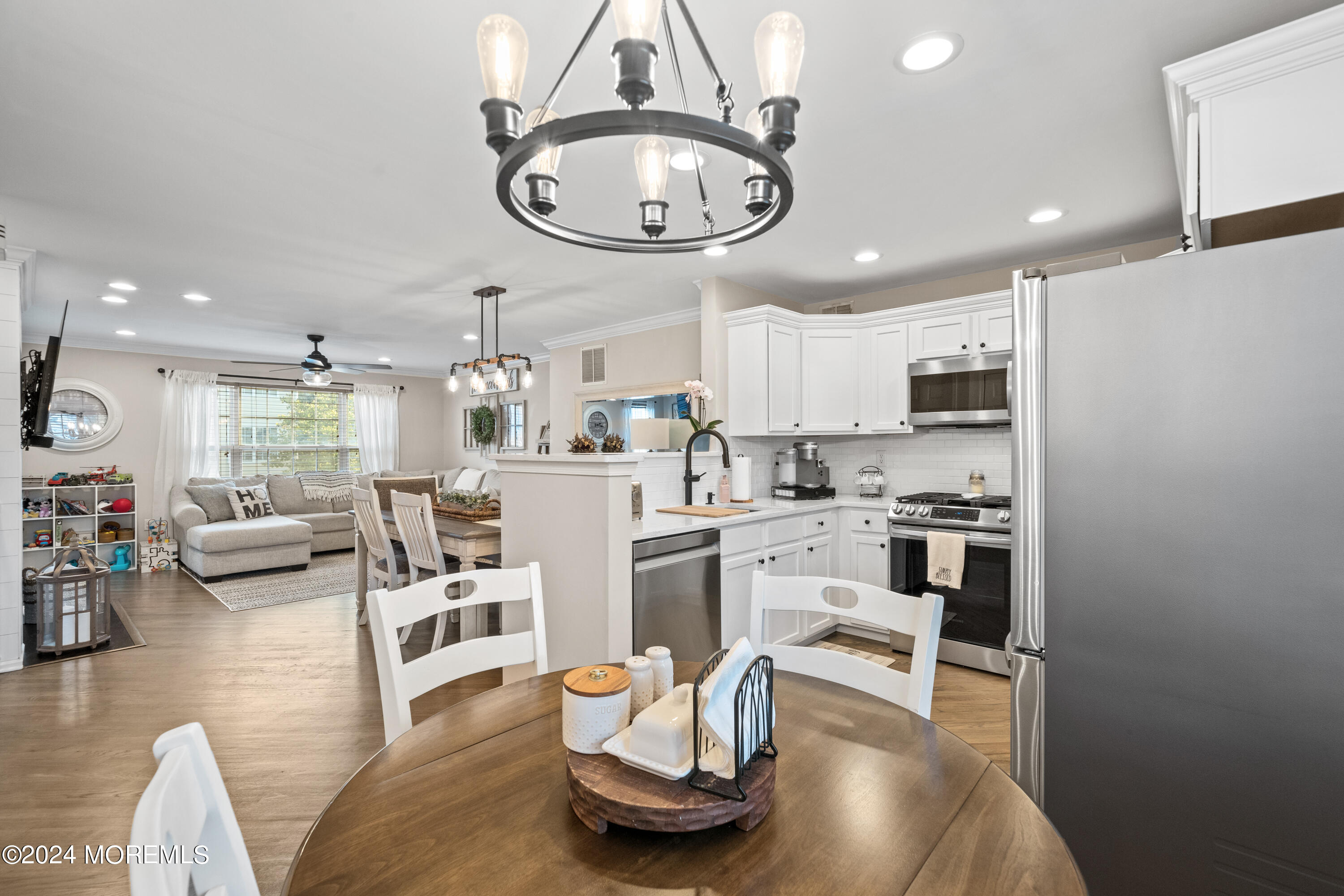 5 Kuczynski Drive, Unit 945 Parlin, NJ 08859 - Photo 10 of 62 a living room with stainless steel appliances furniture a rug and a kitchen view