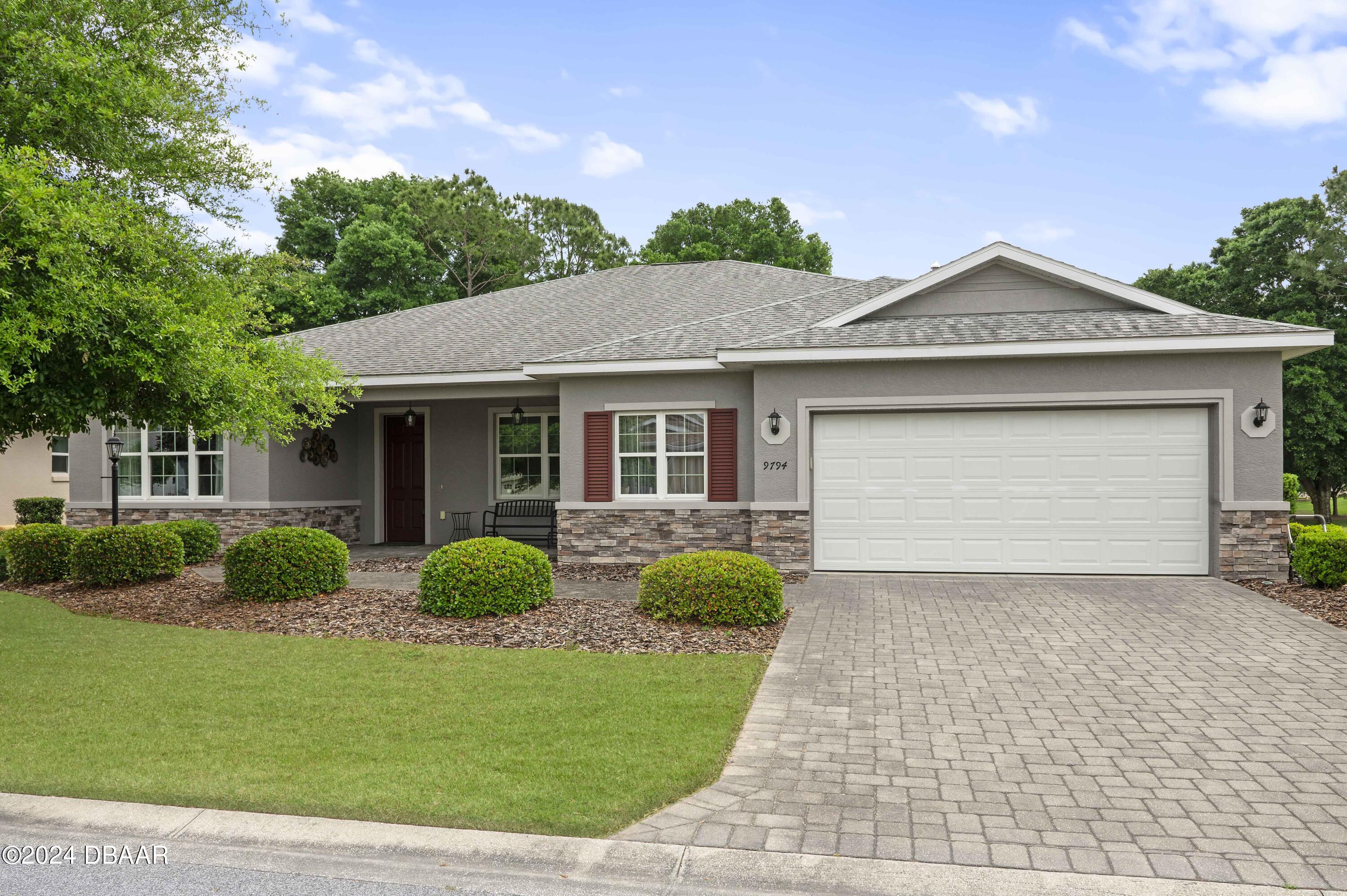 a front view of a house with garden