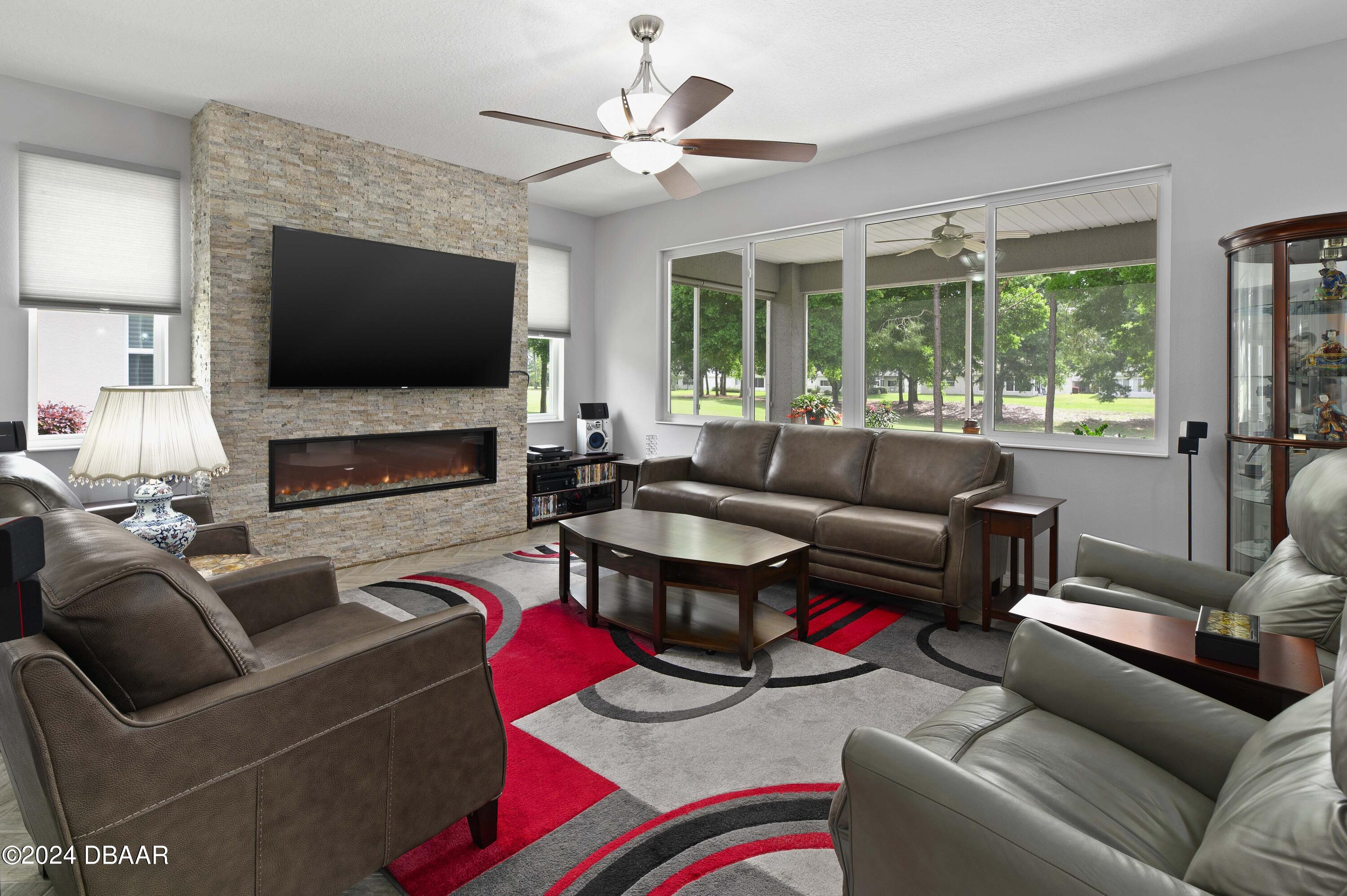 9794 Southwest 92 Street Ocala, FL 34481 - Photo 13 of 39 a living room with furniture and a flat screen tv