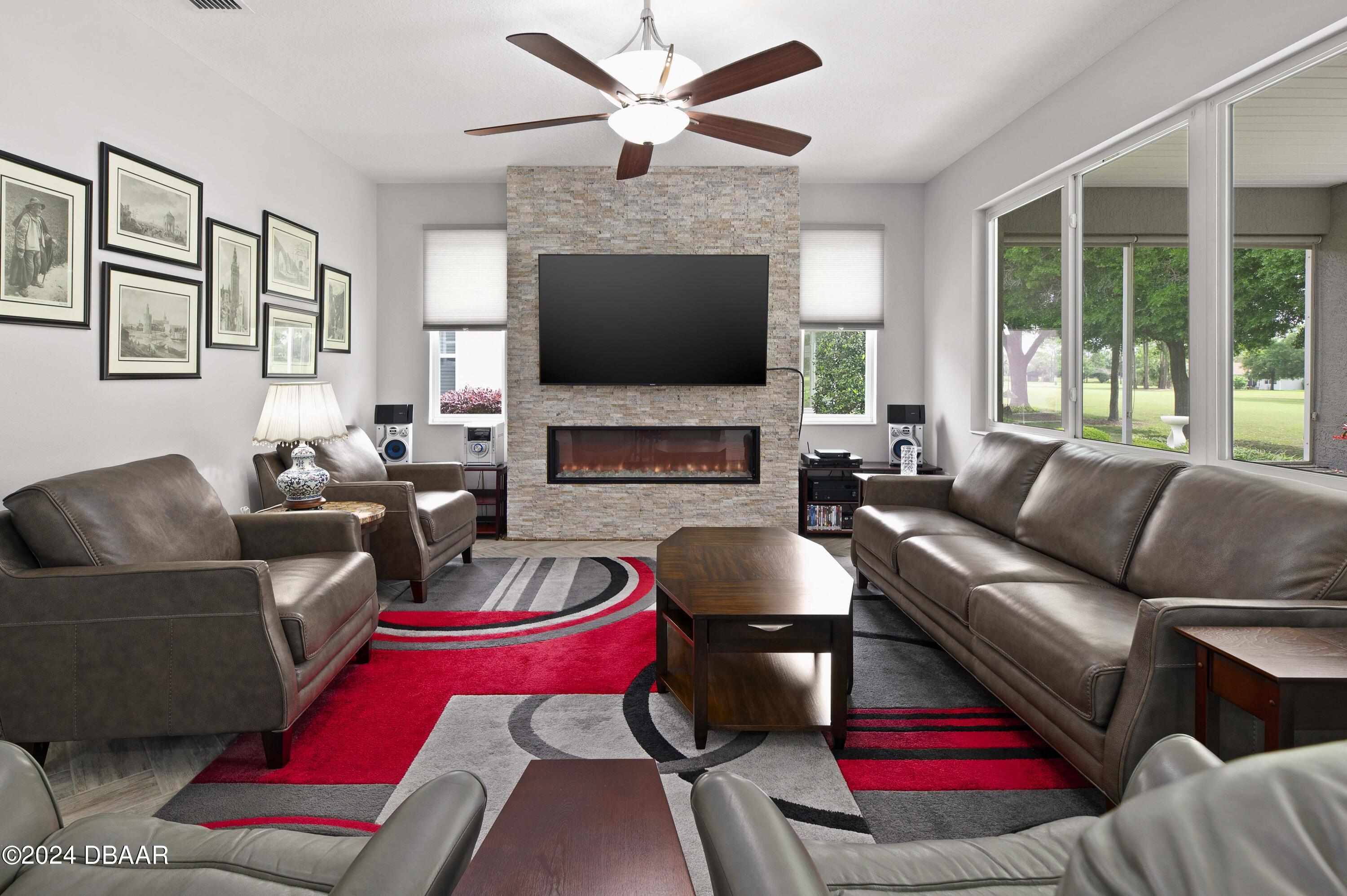 9794 Southwest 92 Street Ocala, FL 34481 - Photo 14 of 39 a living room with furniture fireplace and a flat screen tv