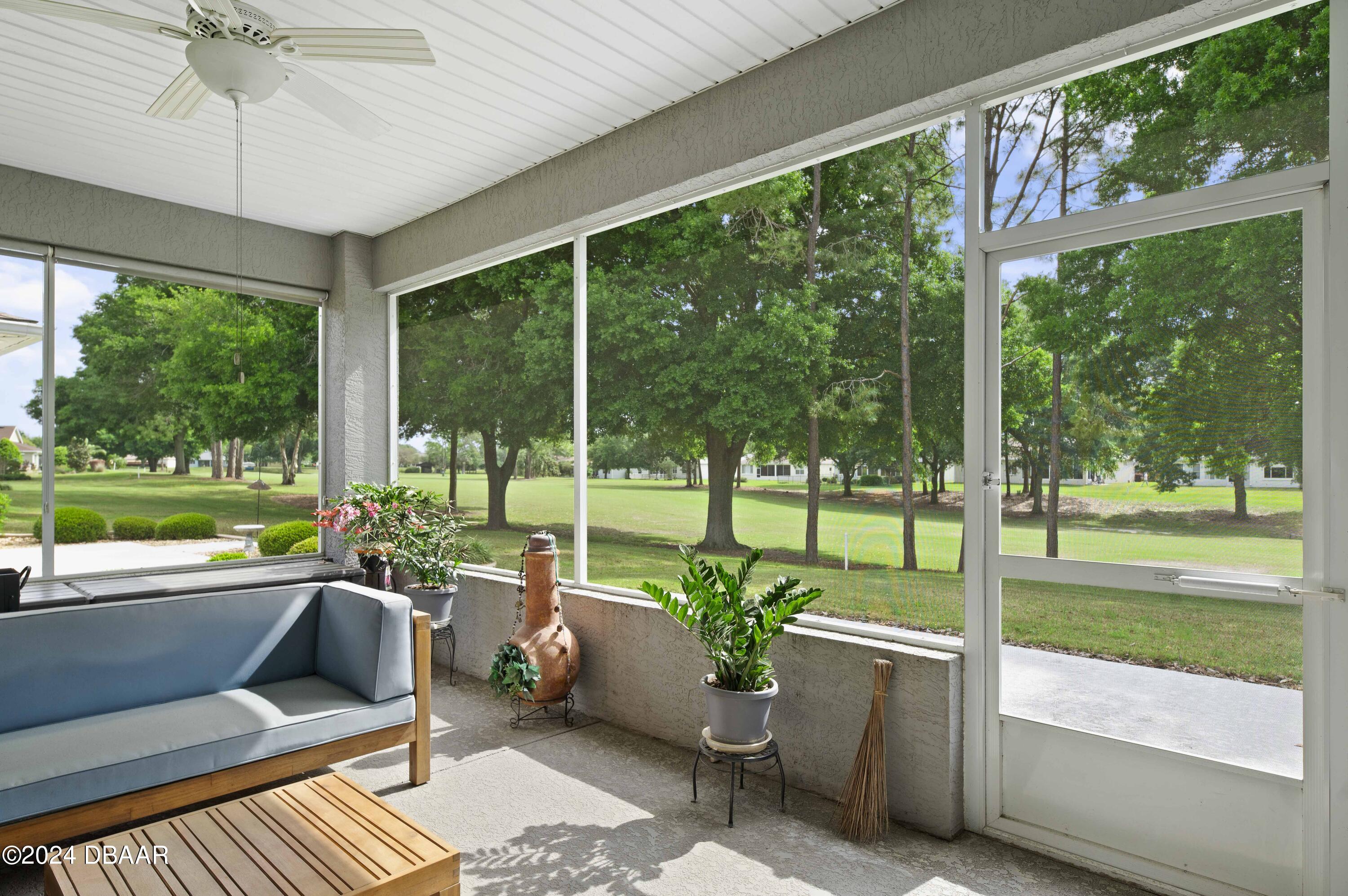 9794 Southwest 92 Street Ocala, FL 34481 - Photo 2 of 39 a building outdoor space with furniture and garden view
