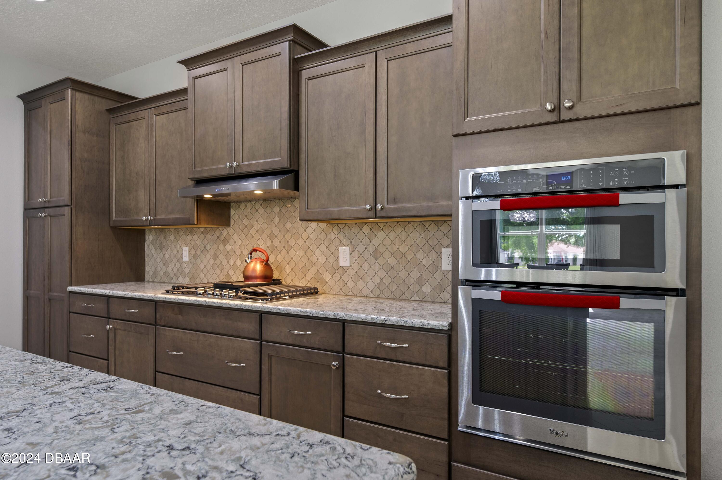 9794 Southwest 92 Street Ocala, FL 34481 - Photo 22 of 39 a kitchen with stainless steel appliances granite countertop a refrigerator and cabinets