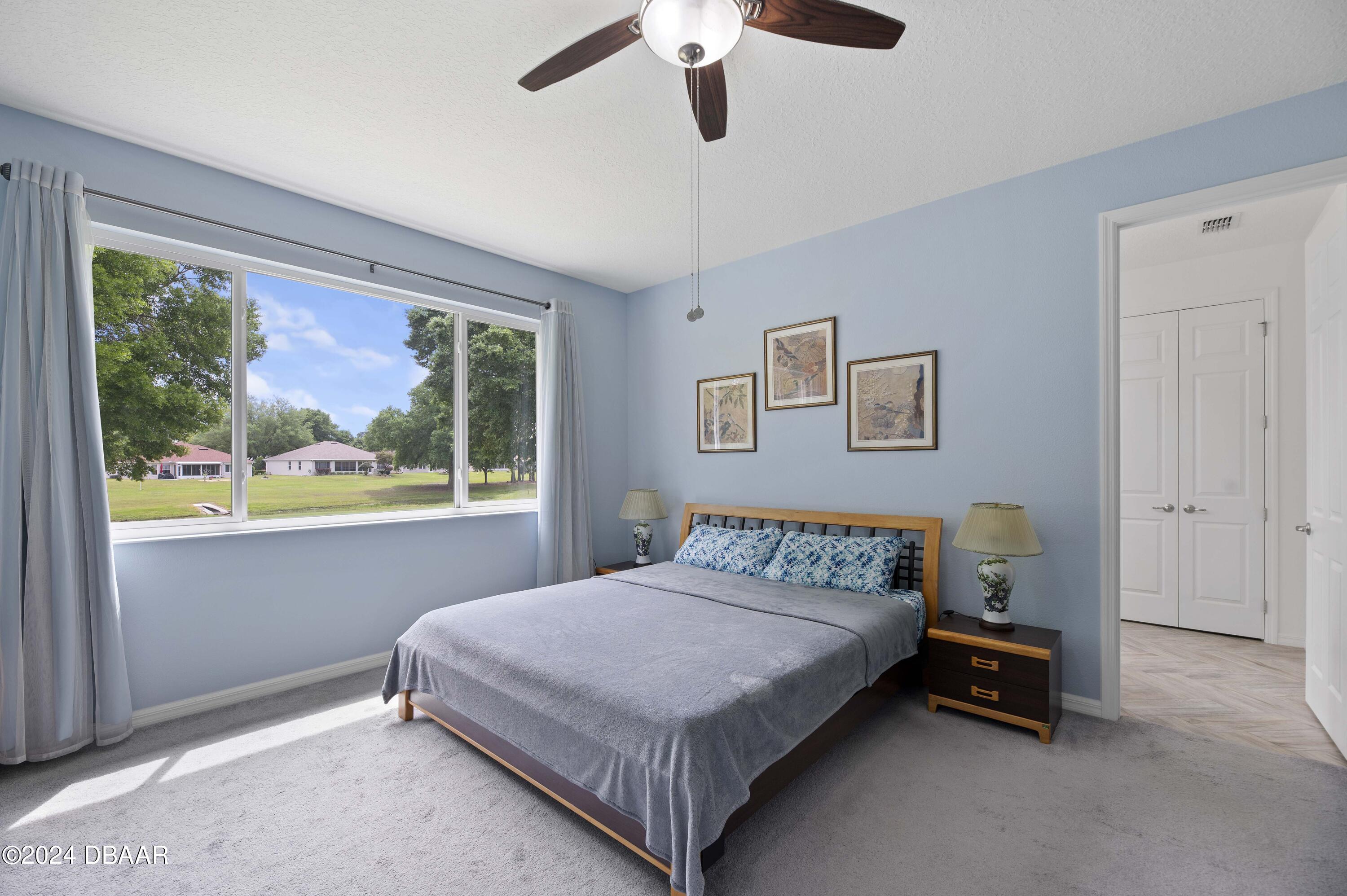 9794 Southwest 92 Street Ocala, FL 34481 - Photo 24 of 39 a bedroom with a bed and a painting on the wall