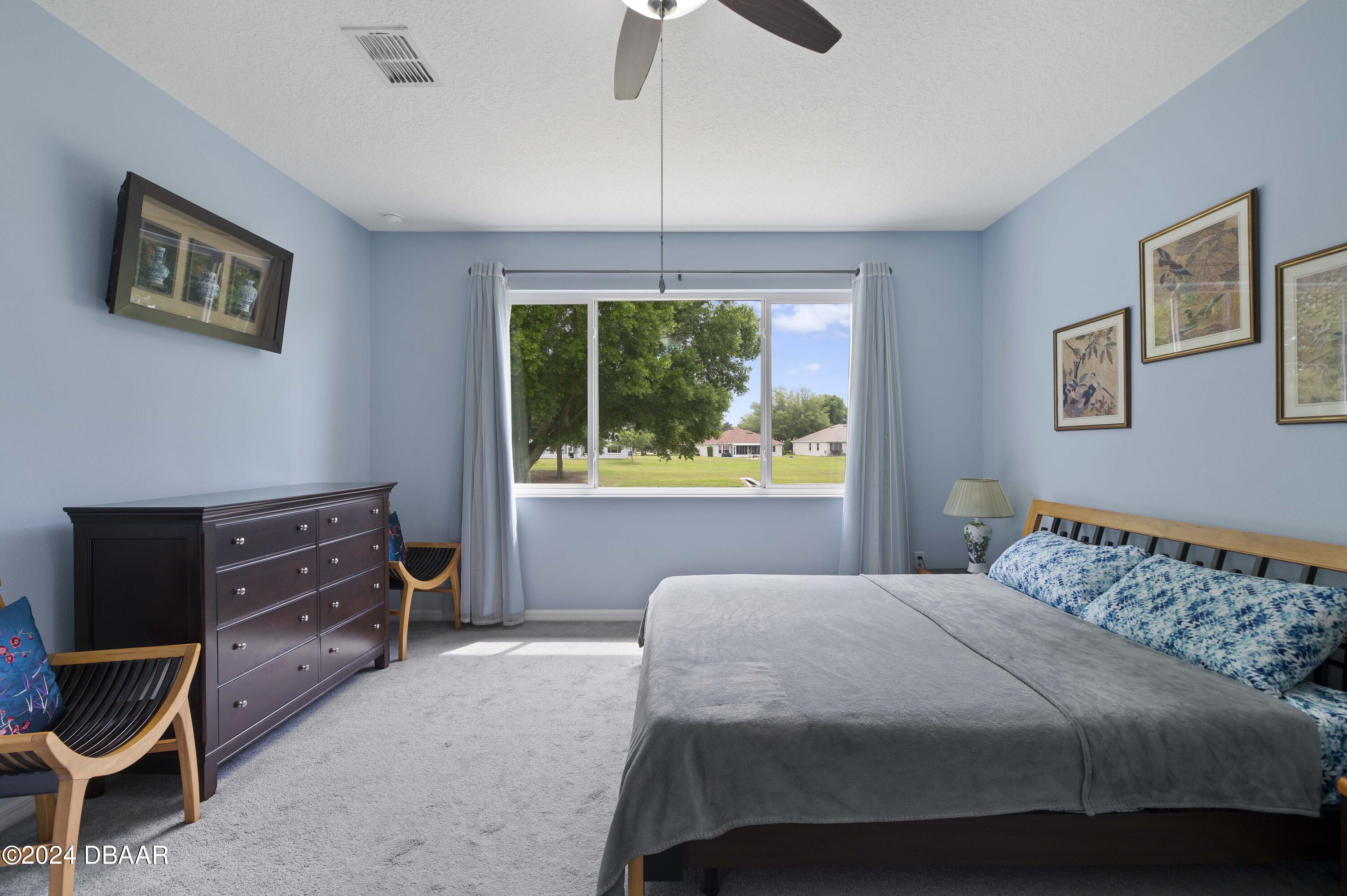 9794 Southwest 92 Street Ocala, FL 34481 - Photo 25 of 39 a bedroom with a bed and a window