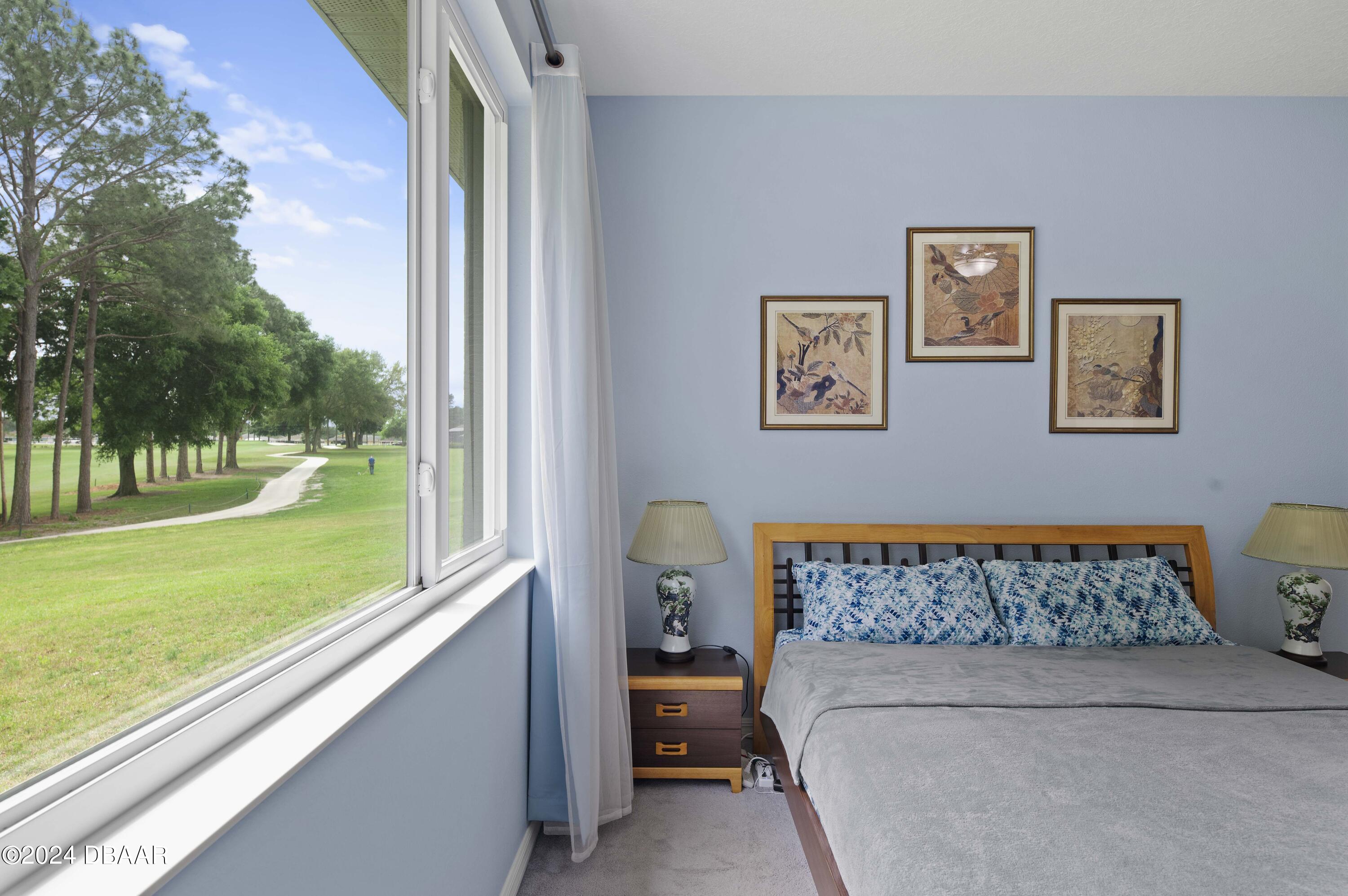 9794 Southwest 92 Street Ocala, FL 34481 - Photo 26 of 39 a bedroom with a bed and a view of bedroom