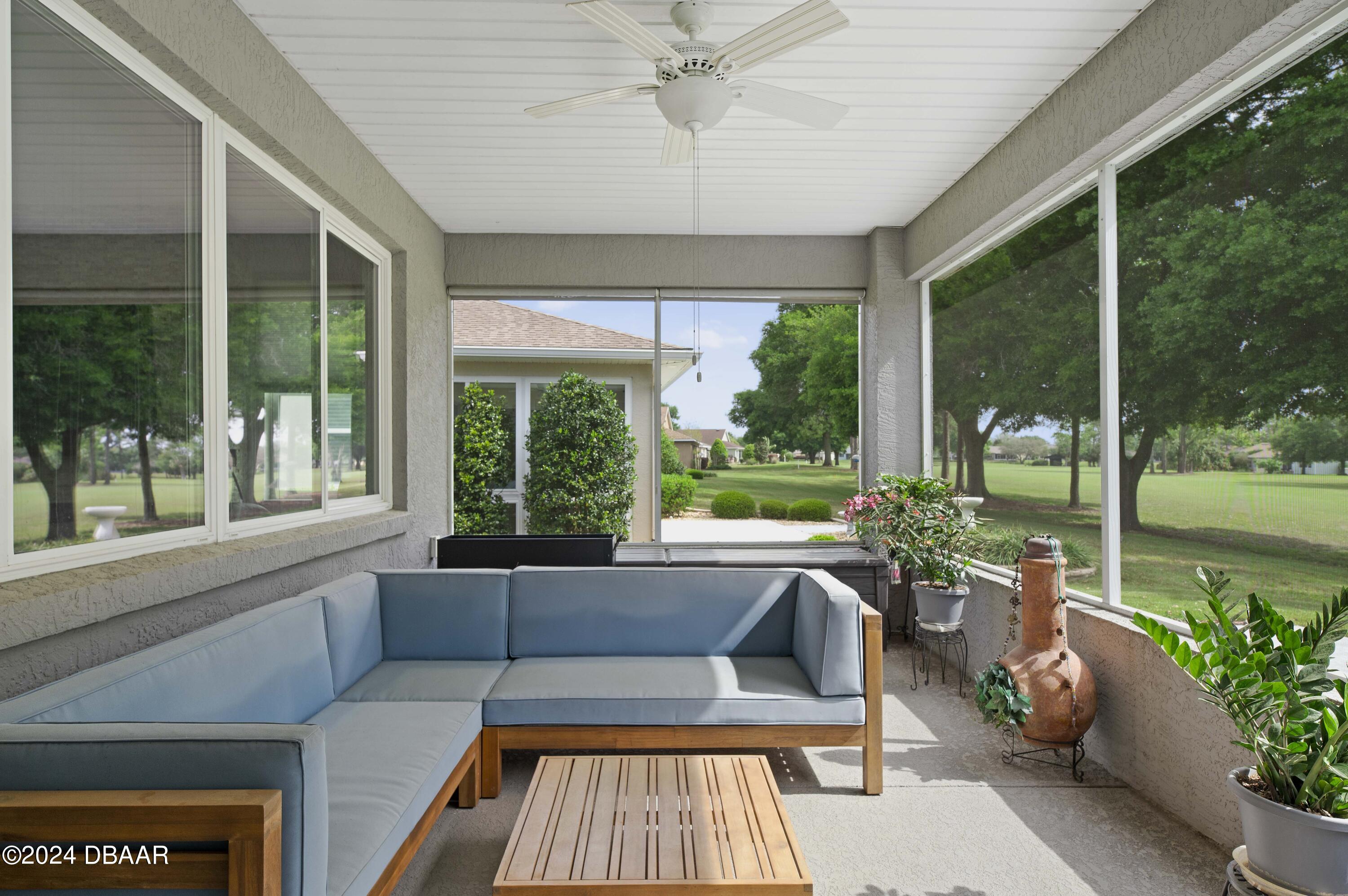 9794 Southwest 92 Street Ocala, FL 34481 - Photo 3 of 39 a living room with furniture and a garden