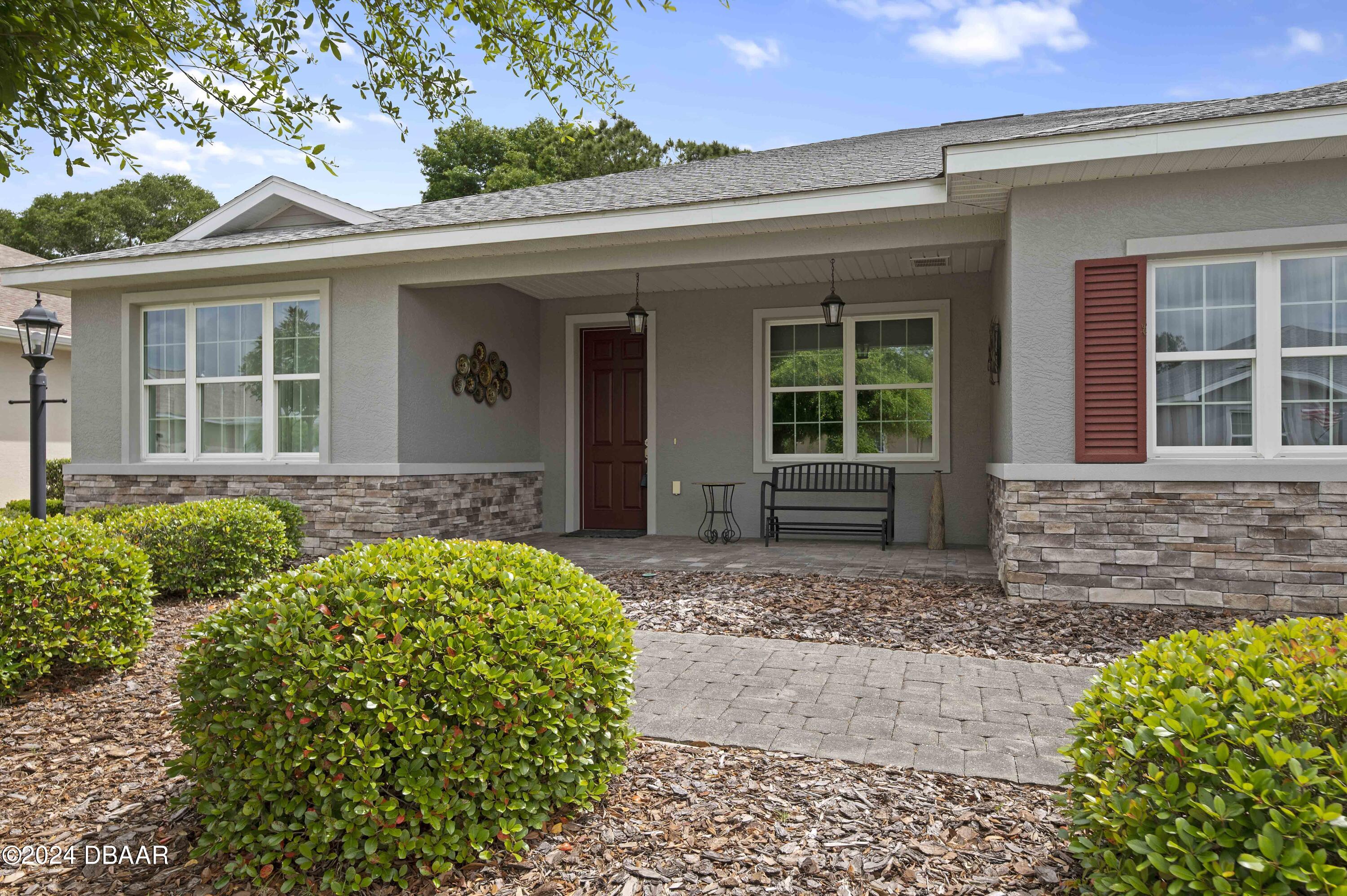 9794 Southwest 92 Street Ocala, FL 34481 - Photo 35 of 39 front view of a house with a small yard