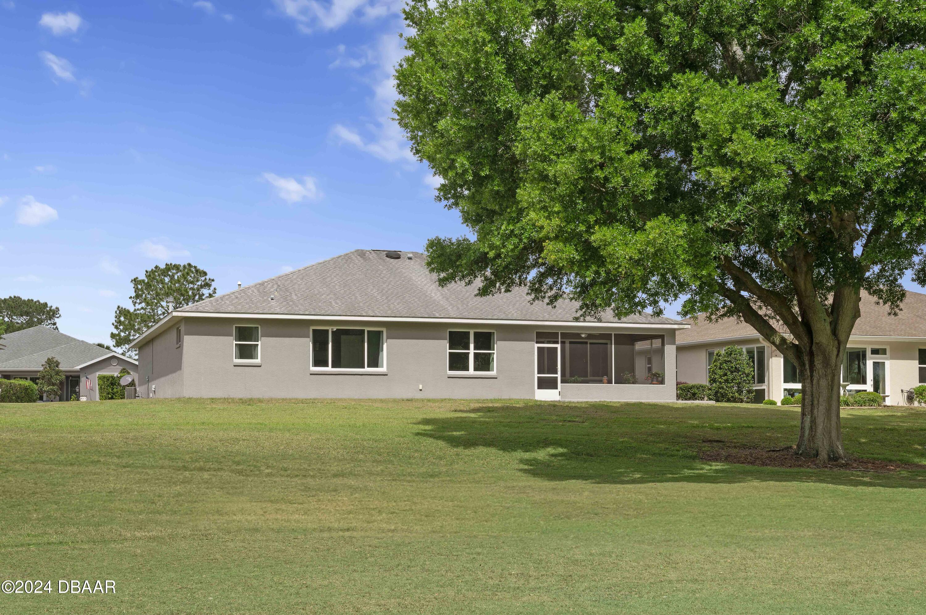 9794 Southwest 92 Street Ocala, FL 34481 - Photo 36 of 39 a front view of a house with a garden