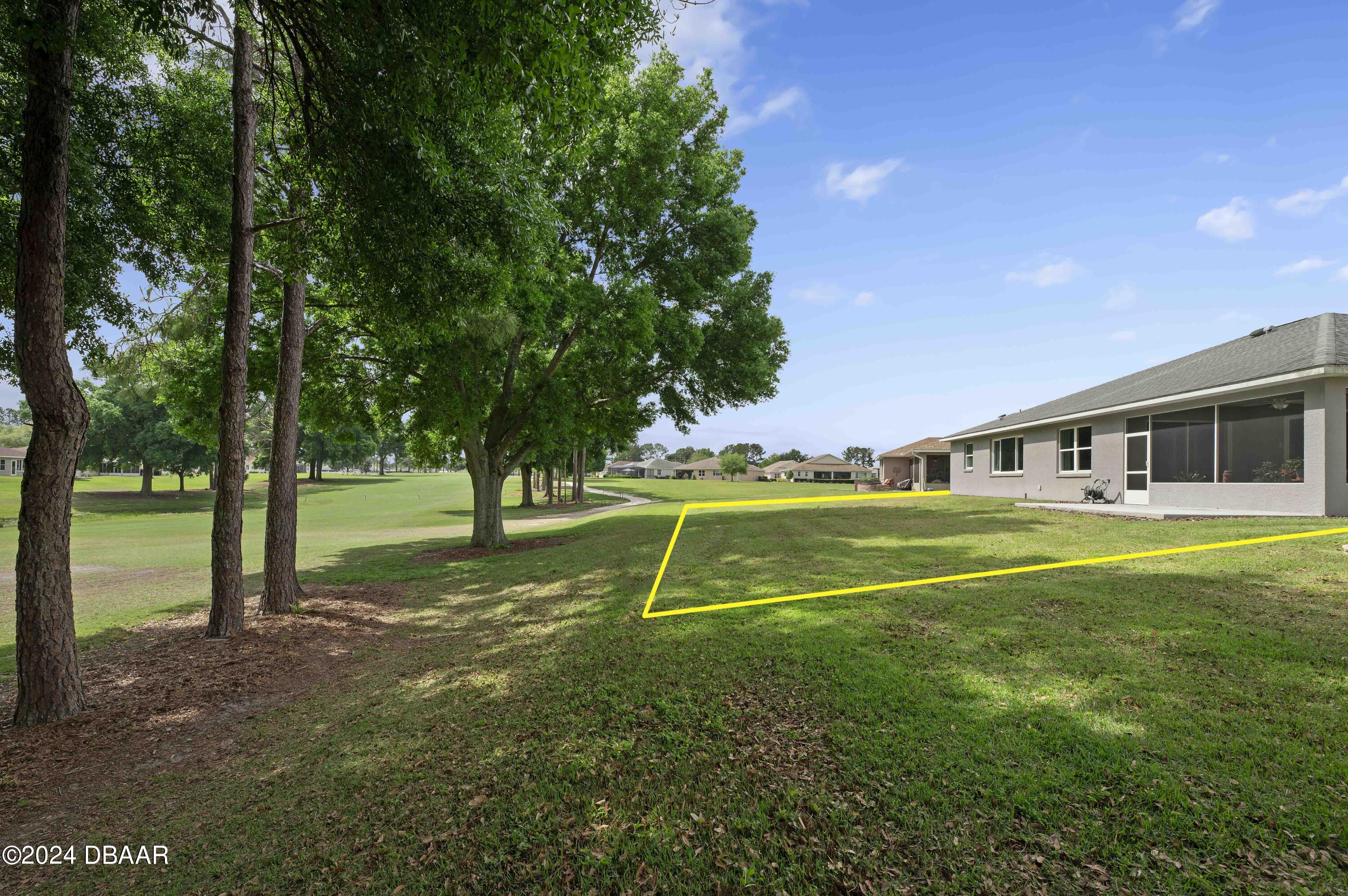 9794 Southwest 92 Street Ocala, FL 34481 - Photo 5 of 39 a view of house with a backyard