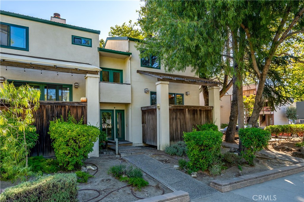 a house that has a tree in front of the house