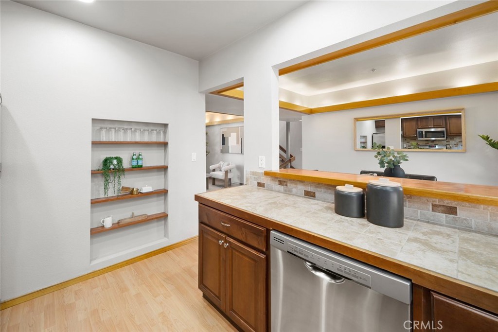 670 Chorro Street, Unit D San Luis Obispo, CA 93401 - Photo 19 of 40 a kitchen with stainless steel appliances granite countertop a sink and a refrigerator