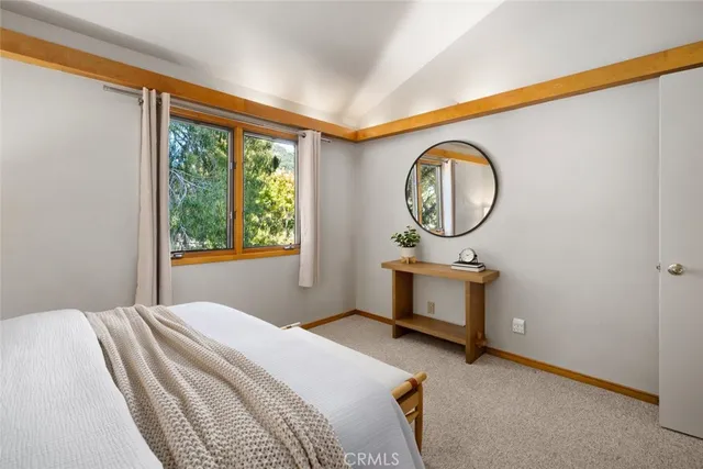 a bedroom with a bed and a view mirror