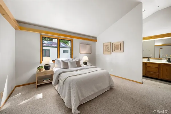 a bedroom with bed and a night stand