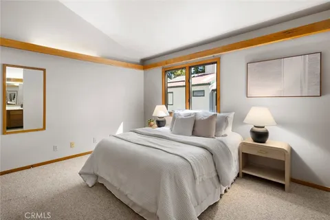 a bedroom with a bed and a desk