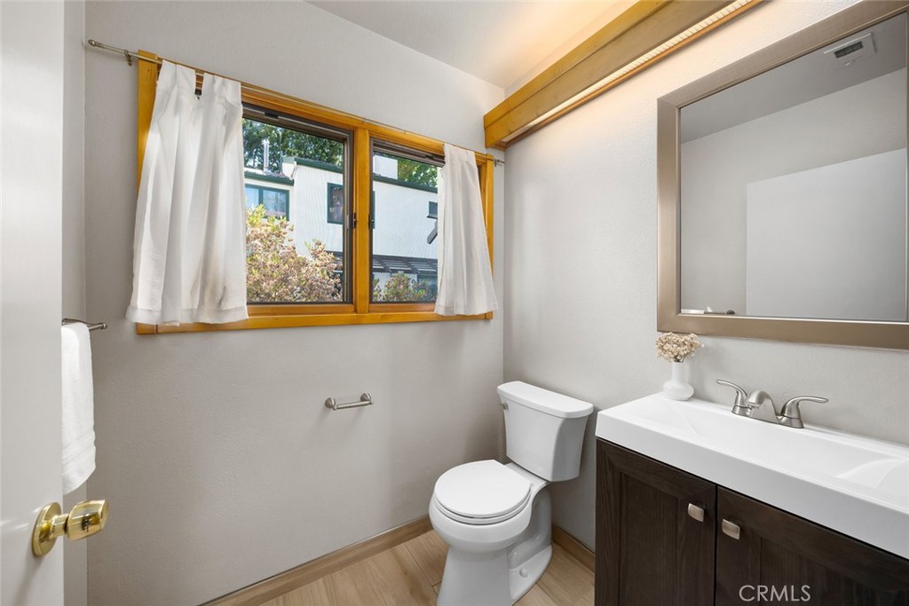 670 Chorro Street, Unit D San Luis Obispo, CA 93401 - Photo 34 of 40 a bathroom with a toilet sink and mirror