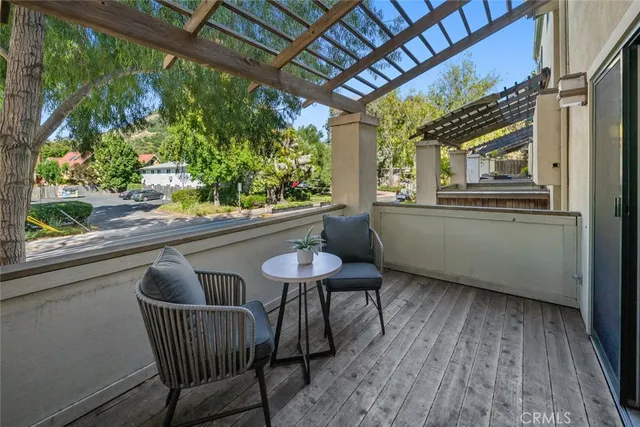 a view of a chair and table in the balcony