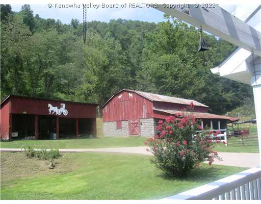 100 Hurricane Road Elkview, WV 25071 - Photo 6 of 8 Exterior Front. 8 stall horse barn which holds 1000 bales hay in loft / 2 Shed Barnes / Riding Rink to R. of barn