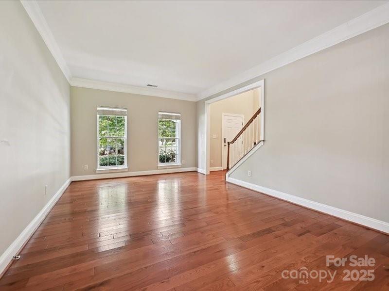 6932 Augustine Way Charlotte, NC 28270 - Photo 11 of 46 an empty room with wooden floor and windows