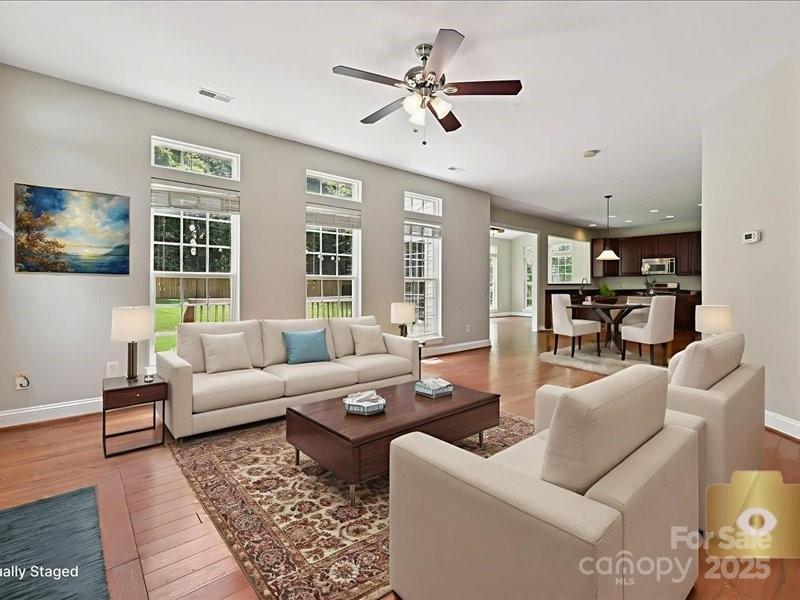 6932 Augustine Way Charlotte, NC 28270 - Photo 17 of 46 a living room with furniture ceiling fan and a rug