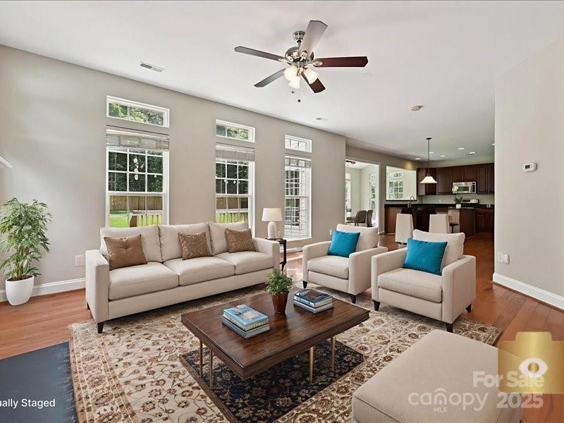 6932 Augustine Way Charlotte, NC 28270 - Photo 19 of 46 a living room with furniture ceiling fan and a window