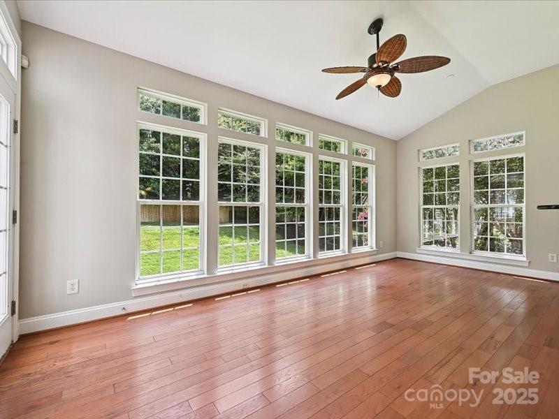 6932 Augustine Way Charlotte, NC 28270 - Photo 21 of 46 a view of an empty room with a window and wooden floor