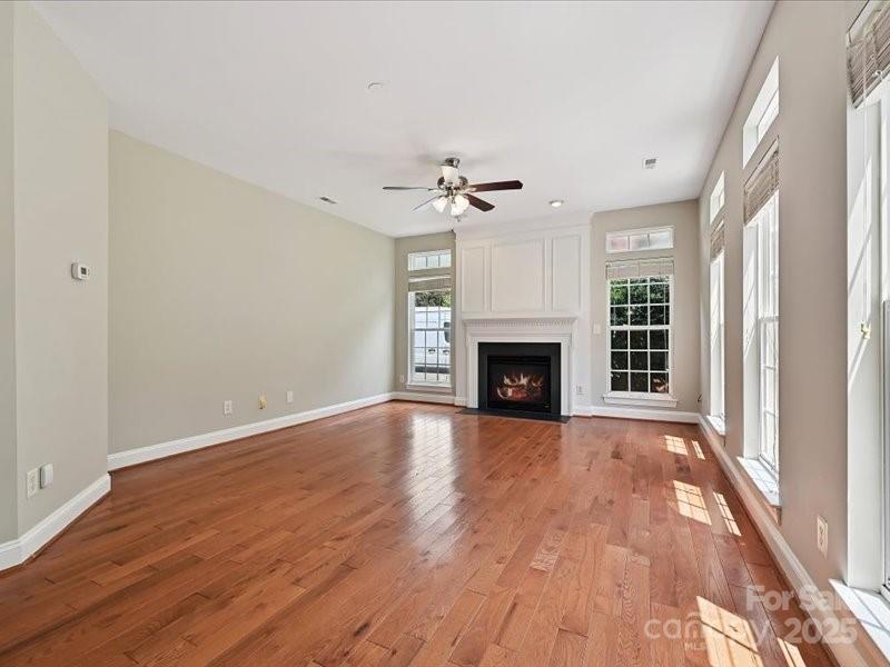 6932 Augustine Way Charlotte, NC 28270 - Photo 27 of 46 wooden floor fireplace and windows in an empty room