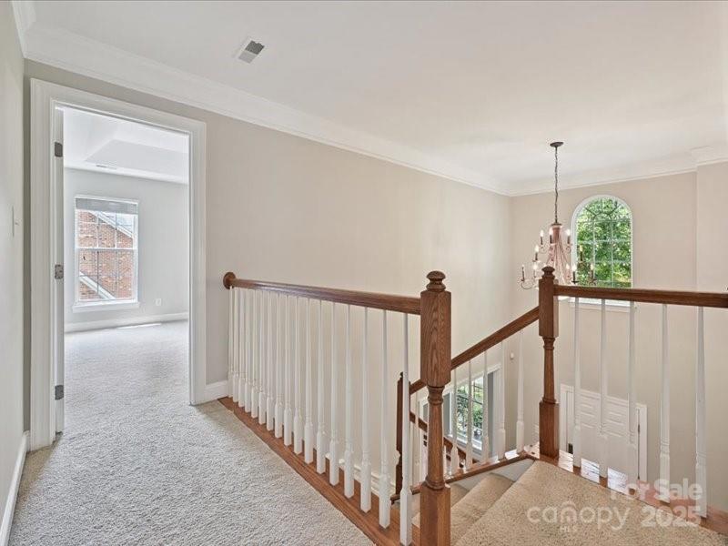 6932 Augustine Way Charlotte, NC 28270 - Photo 28 of 46 a view of staircase with lots of frames on wall and a window