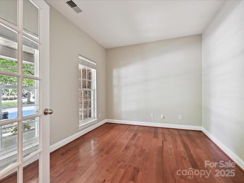 6932 Augustine Way Charlotte, NC 28270 - Photo 4 of 46 a view of an empty room with wooden floor and a window
