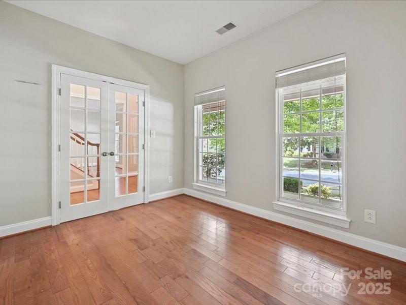 6932 Augustine Way Charlotte, NC 28270 - Photo 5 of 46 an empty room with wooden floor and windows