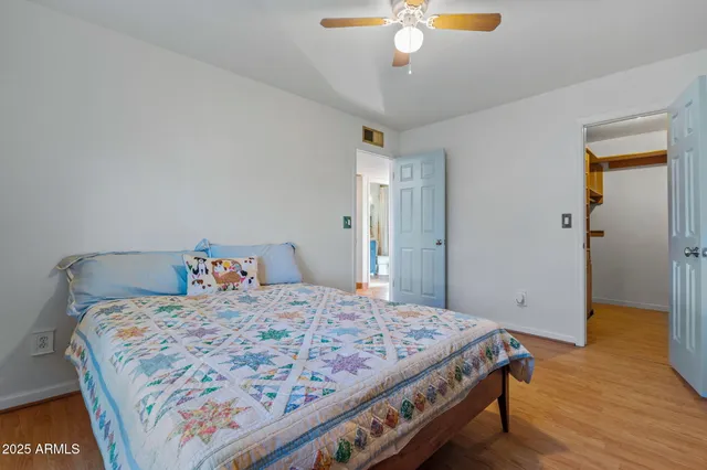 a spacious bedroom with a bed and a window