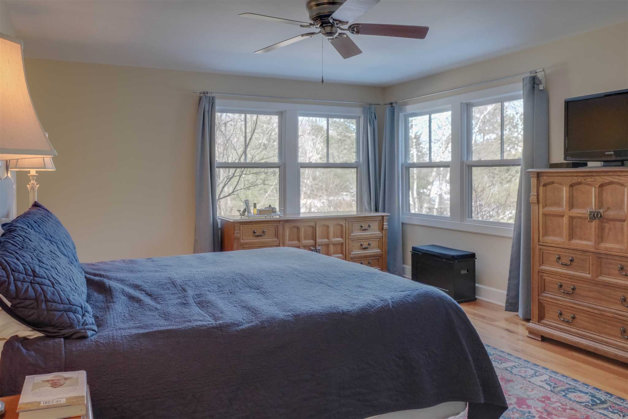 209 Lake Road Pine Plains, NY 12567 - Photo 19 of 34 a spacious bedroom with a bed and a flat screen tv