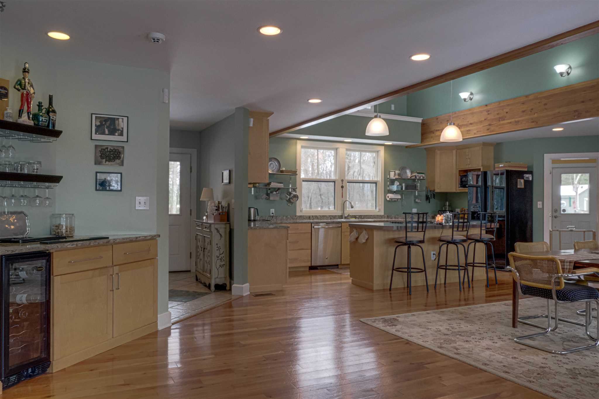 209 Lake Road Pine Plains, NY 12567 - Photo 7 of 34 a kitchen with stainless steel appliances kitchen island granite countertop a refrigerator a sink a stove and white cabinets with wooden floor