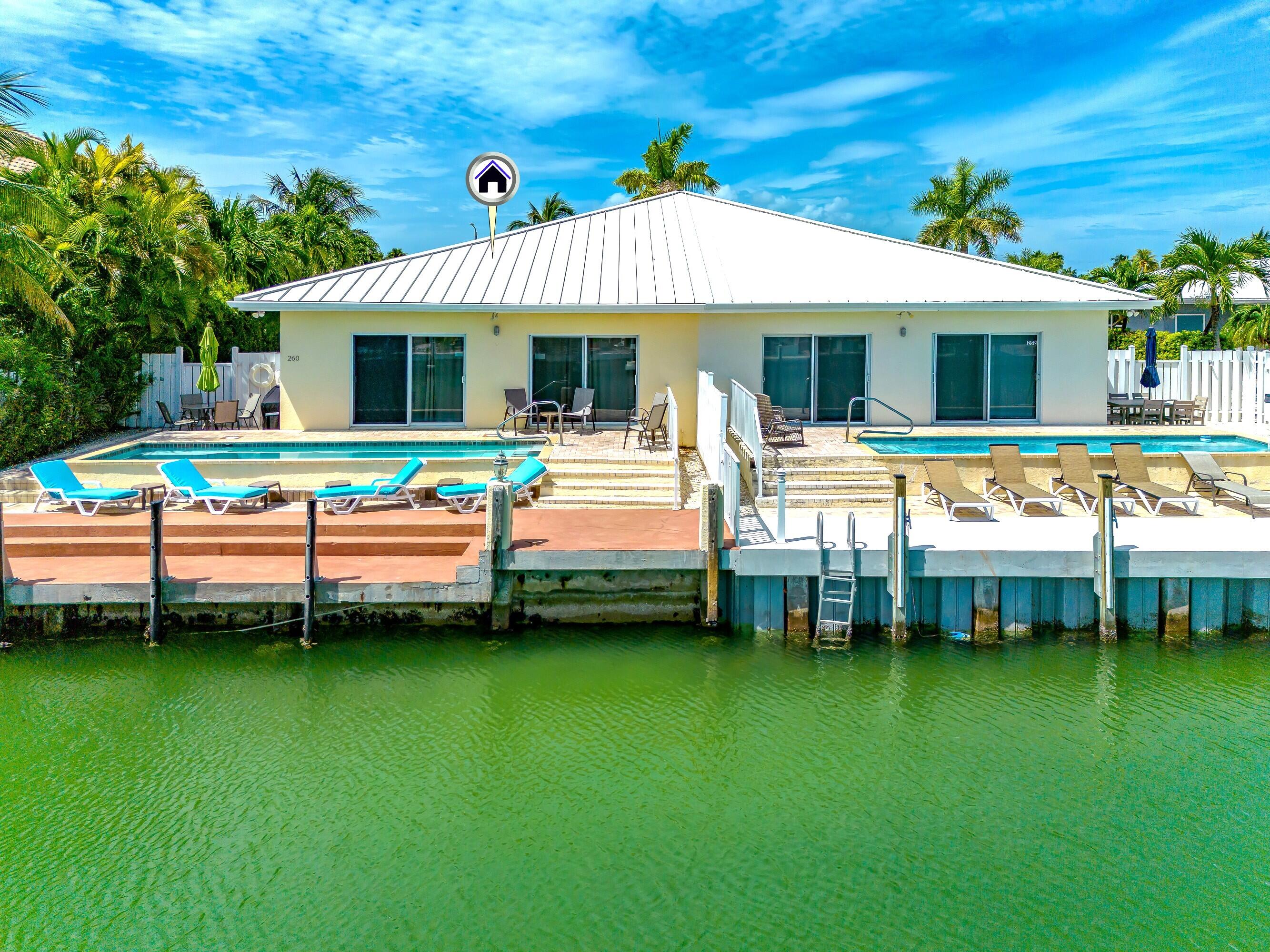 260 Sadowski Causeway Key Colony Beach, FL 33051 - Photo 13 of 50 a front view of a house with a garden
