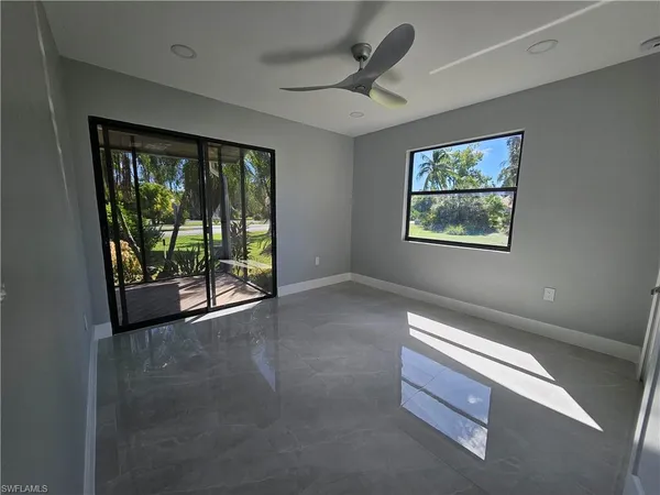 a view of room with window and ceiling fan