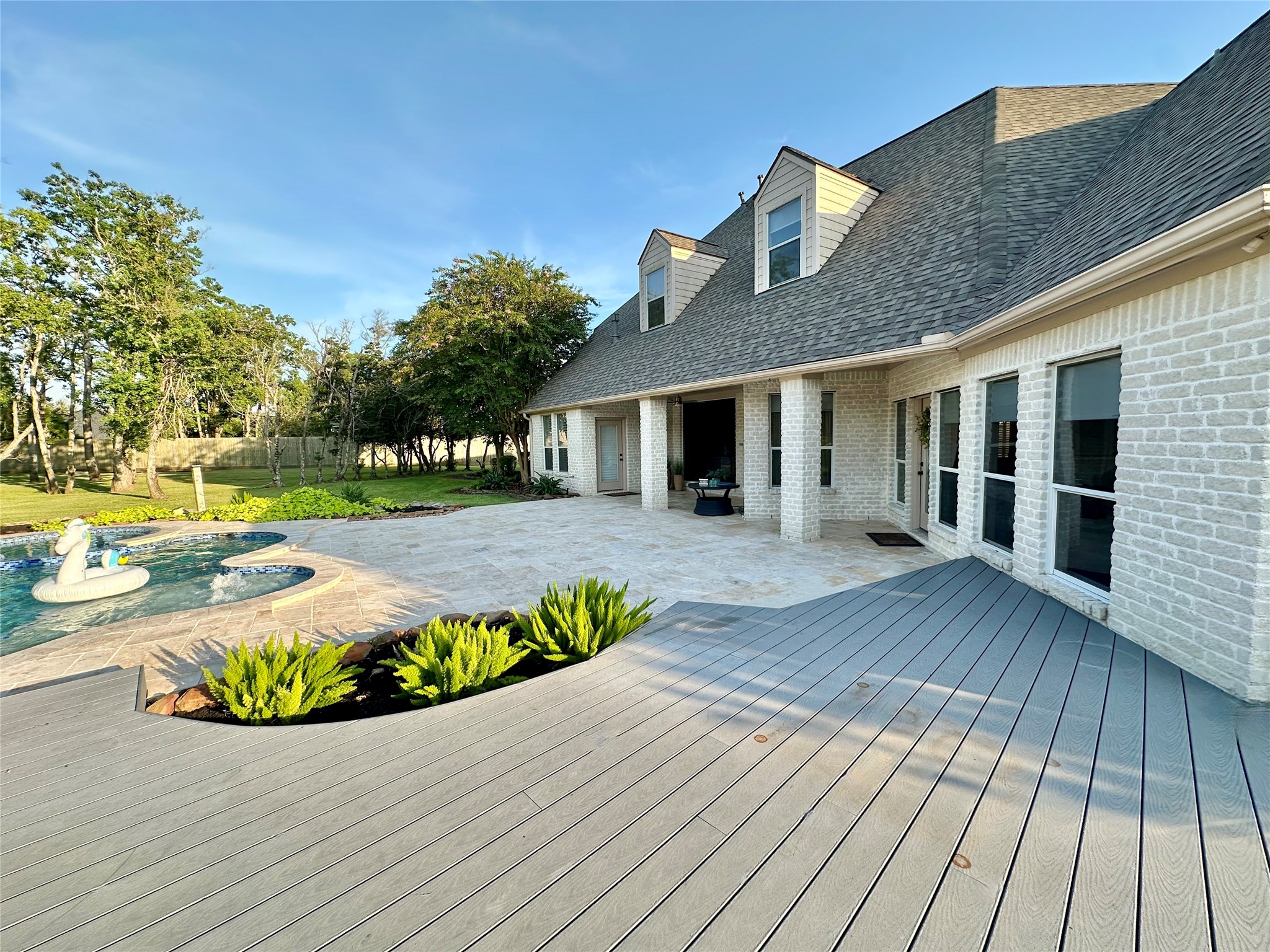 2904 Bridle Path Lane Friendswood, TX 77546 - Photo 39 of 49 The back of the home features multiple sitting areas and endless possibilities—ready for you to design your ideal outdoor retreat, whether for relaxing, entertaining, or soaking in the peaceful views.