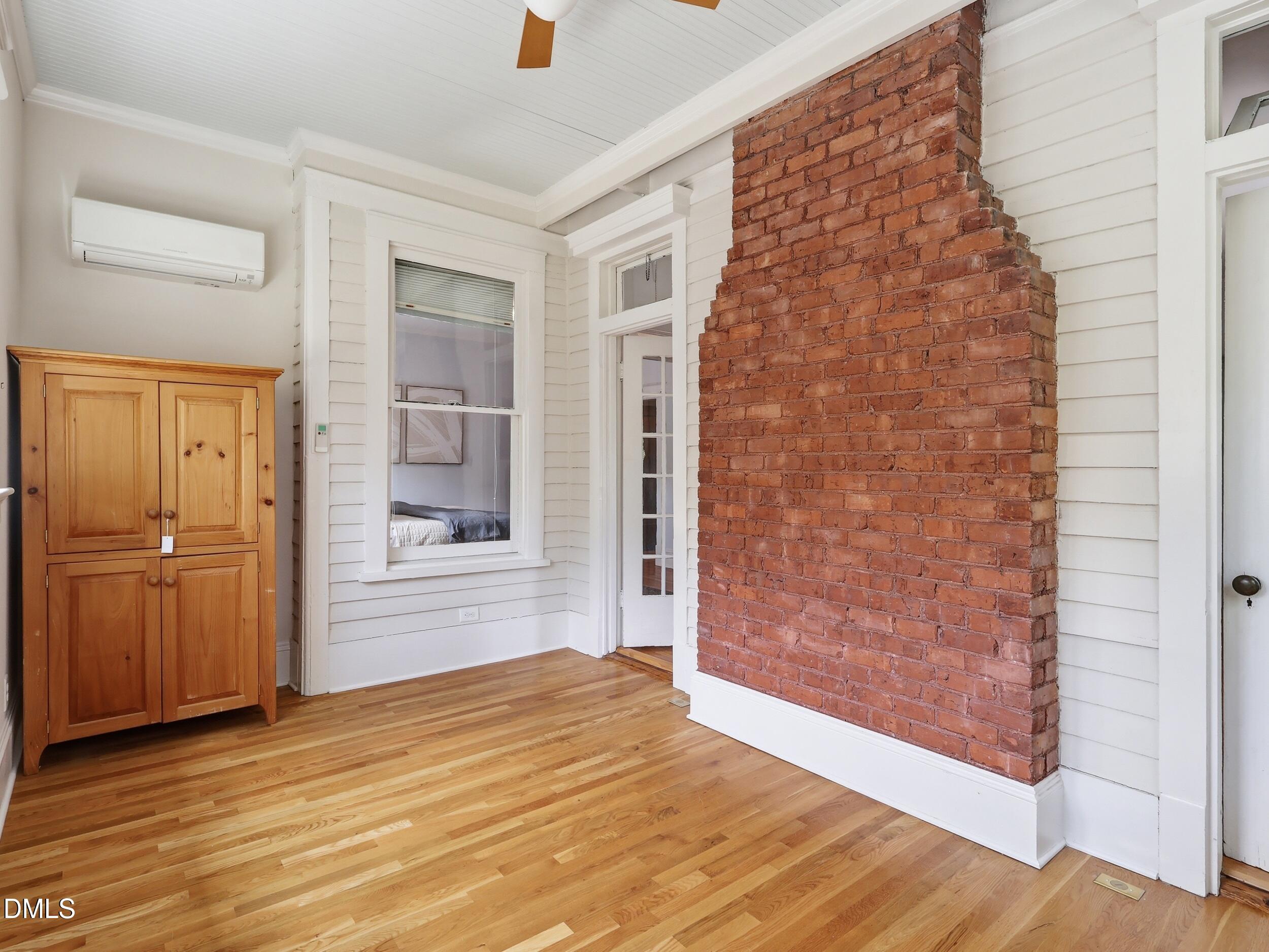 127 Forest Road Raleigh, NC 27605 - Photo 59 of 75 a view of an empty room with wooden floor and a window
