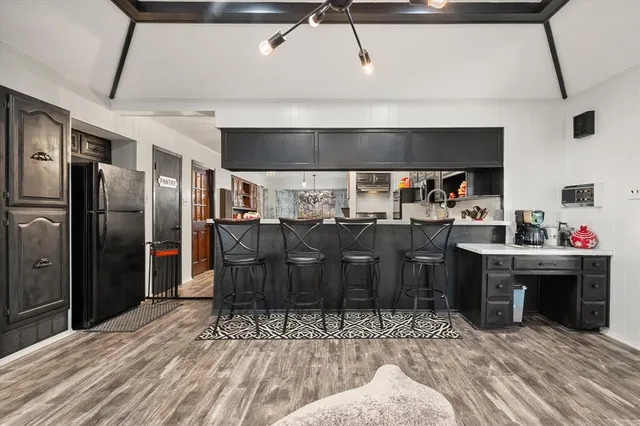 a kitchen with stainless steel appliances kitchen island granite countertop a sink and cabinets