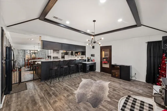a kitchen with a refrigerator and a wooden cabinets