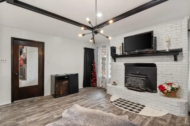 a living room with a fireplace and a flat screen tv