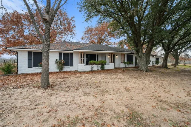 a front view of house with yard and green space