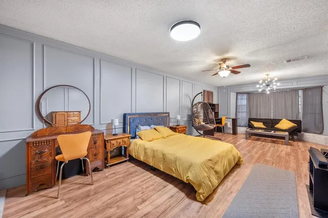 a bed room with two bed and a chandelier