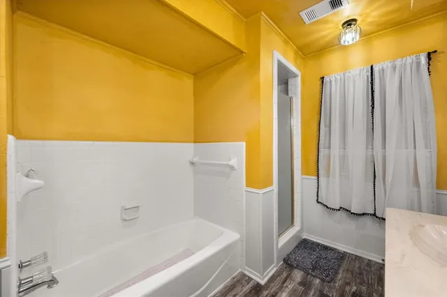 a bathroom with a bathtub and a shower