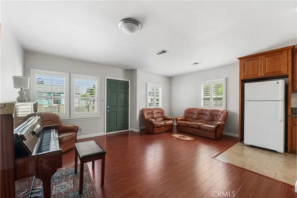 a living room with furniture windows and a wooden floor