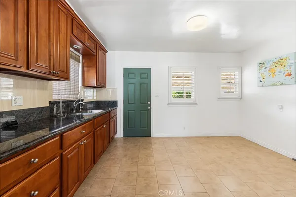 a kitchen with stainless steel appliances granite countertop a refrigerator and a sink