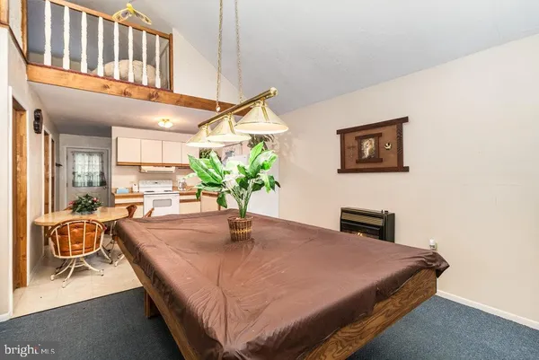 a bedroom with a bed a table and potted plant