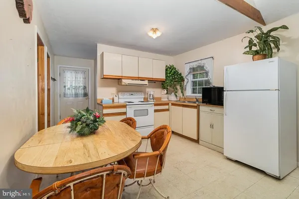 a kitchen with table and chairs