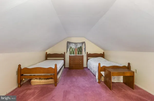 a bedroom with furniture and a wooden floor